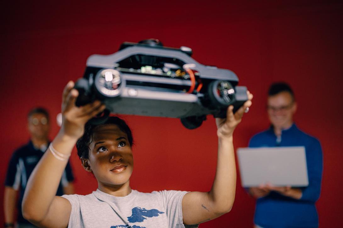 student in lab analyzing vehicle prototype